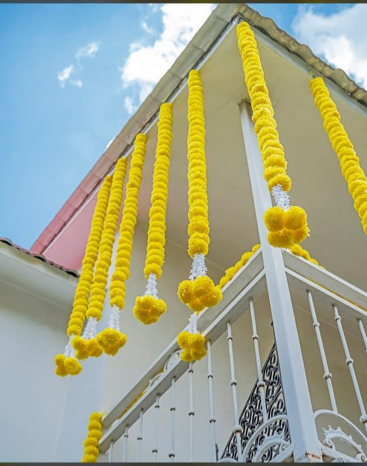 Marigold garlands by House of Artefact hung along a balcony