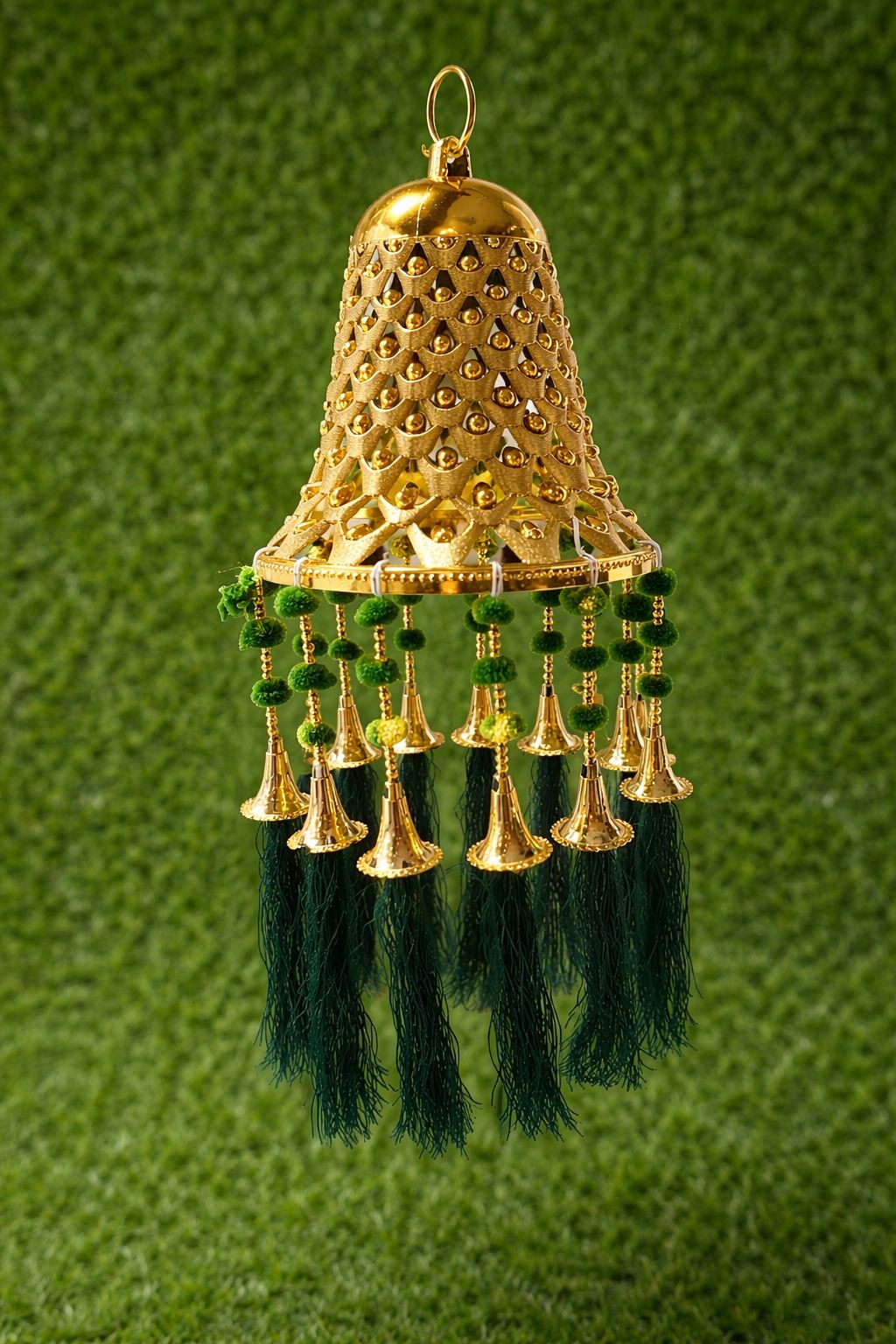 Gold bell hanging with green tassels